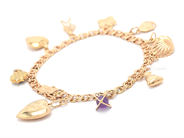 Lot, Bracelet Bismarck with charms 10 items of which one are by non-precious metal and one gravererad 18K 19cm brv 16,8, in auction: Pawn – Tuesday 16 June 2020