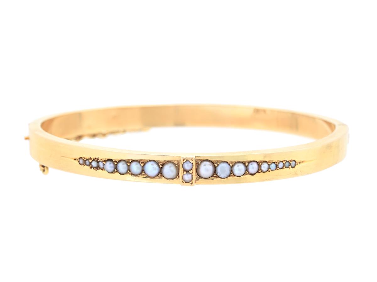 STELT ARMBAND, 18K guld, pärlor, 1900-talets första hälft, innermått 58x51 mm, vikt 10,6 g, säkerhetskedja, små bucklor.
