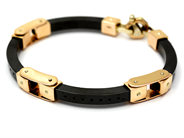 Parti, Armband i svart material och 18K brv: 46g längd ca 20cm, i auktion: Pant – Tisdag 27 september 2016